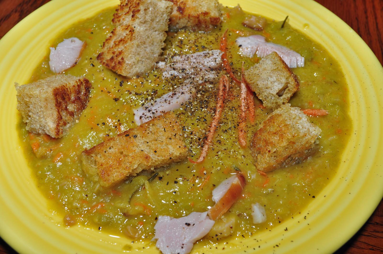 Healthy split pea soup served in a plate on a dinner table